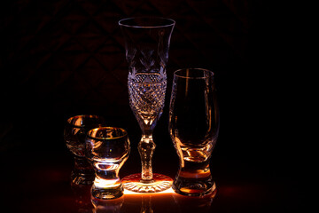 Glasses for wine and champagne and glasses for strong drinks on the bar.