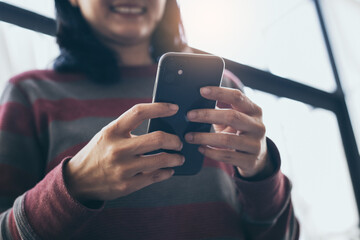 using cell phone hand holding mobile texting message contact us.chatting,search internet...