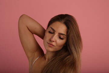 Beautiful woman on pink background in studio