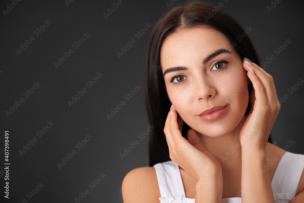 Poster portrait of beautiful young woman on dark grey background. space for text