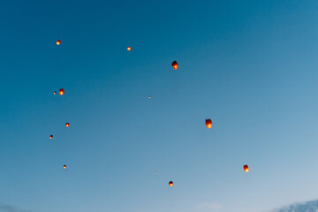 releasing flying lanterns at dusk