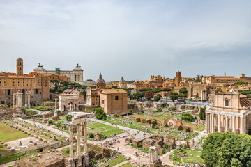 Fototapeta na wymiar Roman Forum in Rome, Italy, It is one of main tourist attractions of Rome. Nice panorama of the famous old Roman Forum or Foro Romano in summer. Ancient architecture and cityscape of historical Rome.