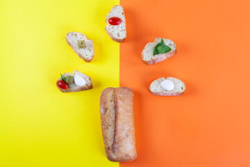 Bread on a bicolor background, orange and yellow 