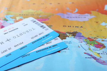 Avia tickets on world map, closeup. Travel agency concept