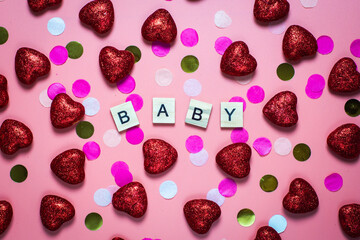 card for valentine's day. on a pink background wooden letters lined with baby. funny congratulations. Flat lay, top view