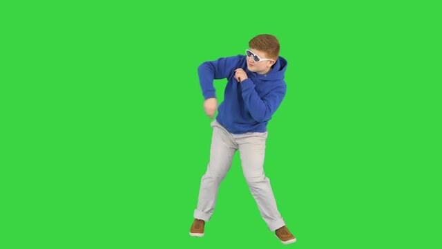 Happy boy in shades dancing really cool on a Green Screen, Chroma Key.