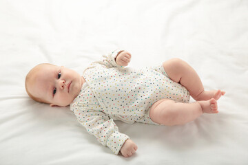 Cute baby girl in bed with copy space.