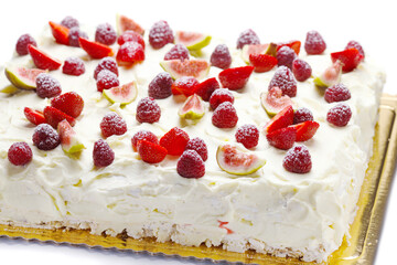 meringue cake with whipped cream and berries - strawberries, raspberries, figs on white