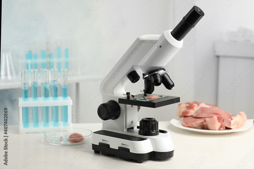 Wall mural slide with meat sample on microscope in laboratory. poison detection