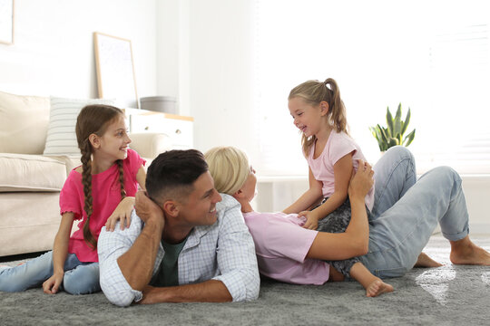 Happy family with children on floor at home