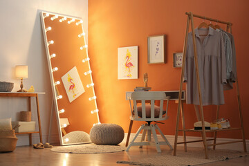 Trendy mirror with light bulbs in stylish room interior