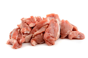 Raw pork meat cut into pieces, isolated on a white background.