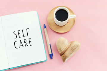 self care concept. notebook with text over pink background