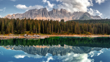 Stunning panoramic view on Lago di Carezza (Karersee), a Beautiful Lake in the Dolomites alps, Italy. Amazing nature landscape.