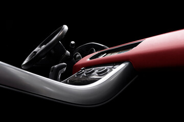 Red luxury modern car Interior. Steering wheel, shift lever and dashboard. Detail of modern car...