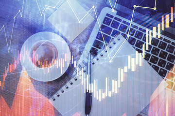 Double exposure of forex chart drawing over table background with computer. Concept of financial research and analysis. Top view.