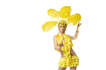 Pointing. Beautiful young woman in carnival masquerade costume with feathers and golden face mask dancing on white background. Concept of holidays celebration, festive time, dance, party. Copyspace