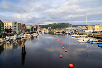 Beautiful cityscapes in Trondheim with river and yachts at dusk in summer