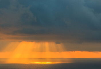 Sunbeams in the sea breaking through the clouds.Concept elements of Nature