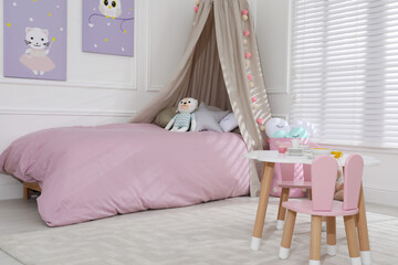 Cute child's room interior with toys and modern furniture