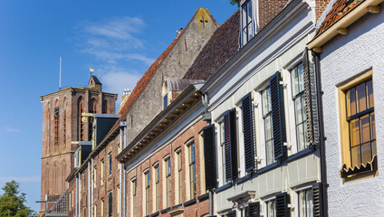 Row of houses and church tower in historic town Elburg, Netherlands