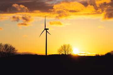 Black Silhouette of windturbines energy generator on amazing sunset at a wind farm in langenberg, germany