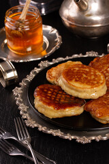 Fresh delicious pancakes lie in a metal dish