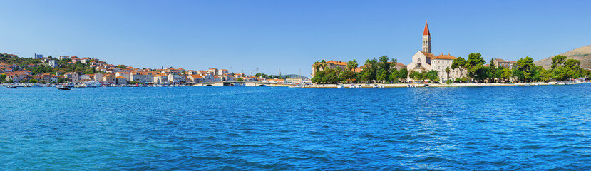 Fototapeta na wymiar Sailing boat anchoring in Trogir town with historic buildings in background, Dalmatia, Croatia