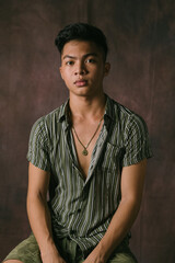 Amazing Portrait Shot a Handsome Filipino Male Model in the Philippines. Serious Asian Guy Posing at the Studio, Looking at the Camera, Posing Isolated over Studio Backdrop Background