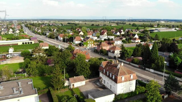 Cottages and buildings at Wintzenheim, France, wide Route de Colmar road, aerial shot. Green small town at Alsace region, famous vine production and touristic area at Haut-Rhin