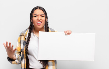 hispanic woman looking angry, annoyed and frustrated screaming wtf or what’s wrong with you