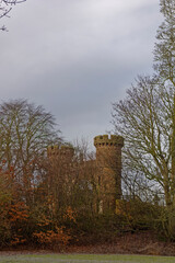 The North Gate Entrance to Letham Grange near Arbroath on a cold winters morning, partially hidden by the bare branches of large trees nearby.