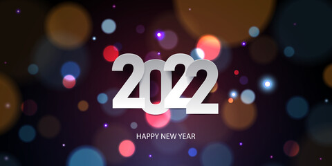 Happy New Year 2022. Holiday greeting card design. White paper numbers on a defocused colorful, bokeh background.