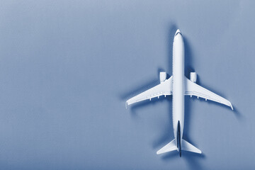 Model of passenger airplane on paper background. Classic blue tone