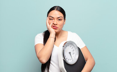hispanic woman feeling bored, frustrated and sleepy after a tiresome, dull and tedious task,...