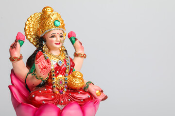 Beautiful Clay Idol of Hindu Goddess Lakshmi OR Laxmi on white background