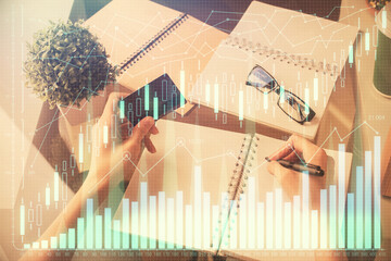 Multi exposure of woman on-line shopping holding a credit card and financial graph drawing. Stock market E-commerce concept.