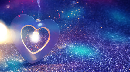 Romantic background for Valentine's Day. Garland in the shape of a heart close up on a shiny surface, bokeh