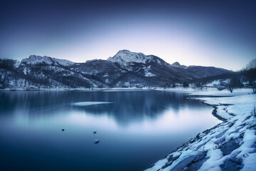 Gramolazzo iced lake and snow in Apuan mountains. Garfagnana, Tuscany, Italy