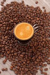Cup of coffee with roasted coffee beans