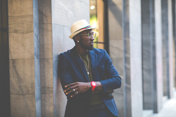 Portrait of handsome afro man in dark blue color suit and hat hipster and vintage style.