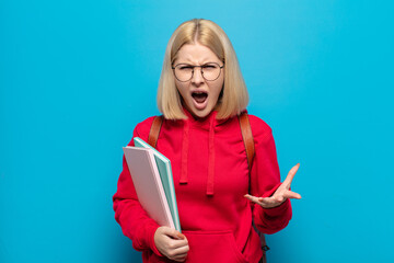 blonde woman looking angry, annoyed and frustrated screaming wtf or what’s wrong with you