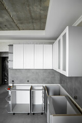 Custom kitchen cabinets installation with a white furniture facades mdf. Gray modular kitchen from...