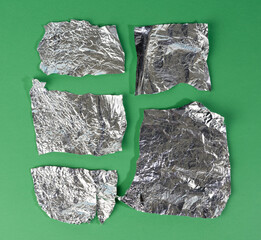 various pieces of foil on a green background