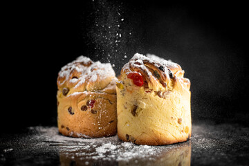 cruffins, The modern baking trend of the year is puffmuffin, a mix of croissants and cupcakes. On a black background sprinkled with powdered sugar
