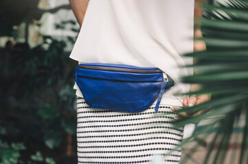 Blue Leather Banana Bag. The model carries a small, comfortable travel bag.