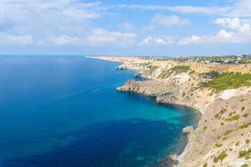 Naklejka na ściany i meble panorama of the sea mountain coast, Crimea the Black Sea coast on a sunny day . rocks on the shore, blue sky