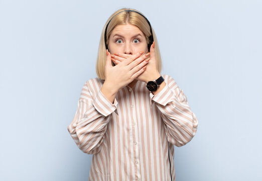 blonde woman covering mouth with hands with a shocked, surprised expression, keeping a secret or saying oops