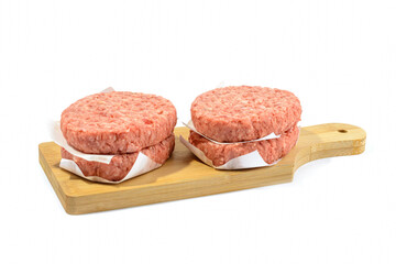 Raw beef patties for making a burger.Isolated on a white background.
