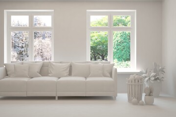 White living room with sofa. Summer and winter landscape in window. 3D illustration